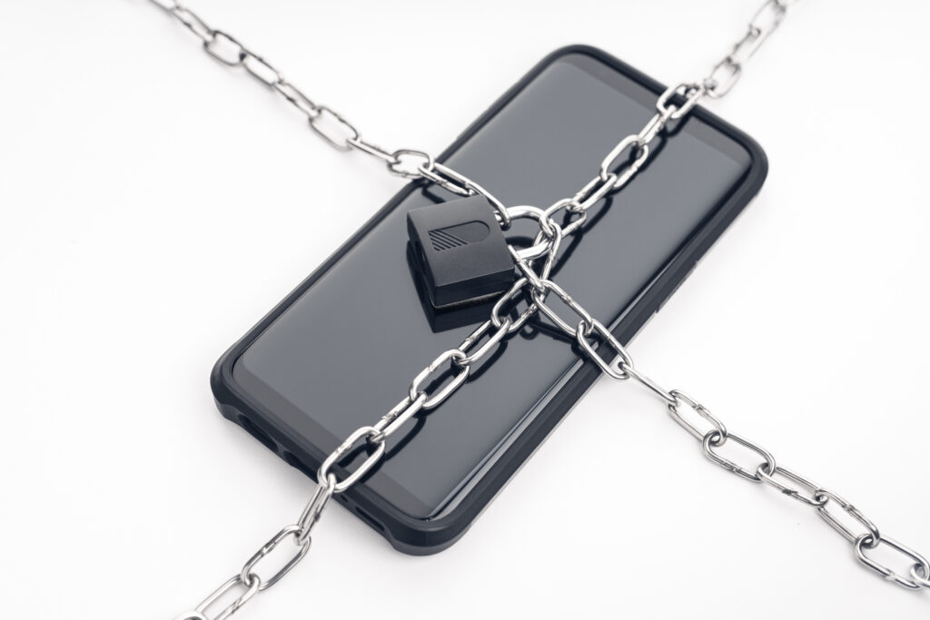 Black Smartphone chained and locked on the white background 